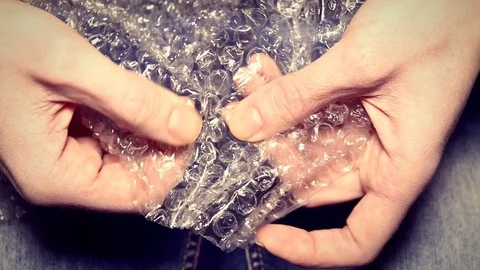 Woman pops plastic bubble wrap. Stock Footage 72782158
