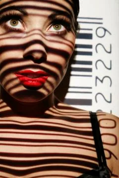 Woman portrait with projected bar code as a symbolic image for biometrics 写真素材