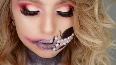 Woman poses for the camera in the studio. makeup for Halloween Stock-Footage 97458053