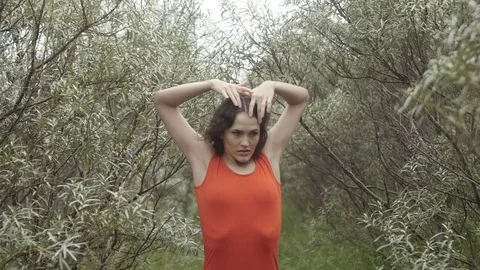Woman posing for camera in brushwood Видео 80767596