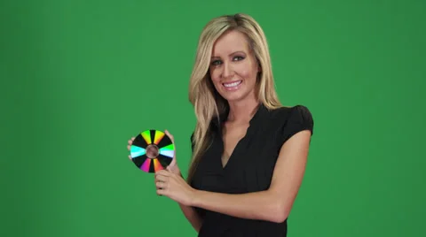 Woman posing in front of a green screen with a CD Stock-Footage 38893048