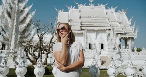 Woman posing in front of White temple Wat Rong Khun in Chiang Rai, Thailand Stock Footage 178557713