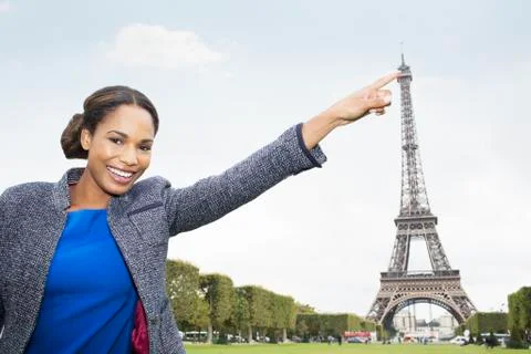 Woman posing as if to touch Eiffel Tower, Paris, France Fotos de archivo