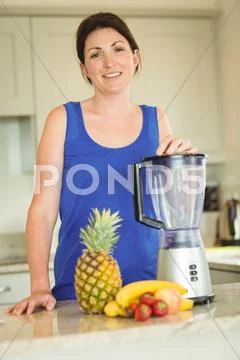 Woman Posing With A Mixer In Kitchen