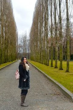 Woman posing on tree-lined path at Treptower Park, Berlin. Stock Photos