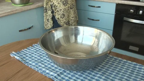 A woman pours water in a bowl Stock Footage