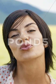 Woman Pouting Lips In Park Stock Photos