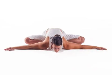 Woman practicing the "bound angle pose" yoga posture Stock Photos