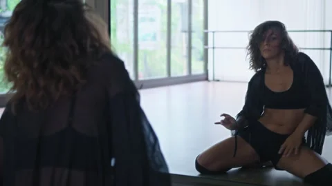 Woman practicing in dance hall, moving her sexy body sensually and smoothly Stock Footage 244984619