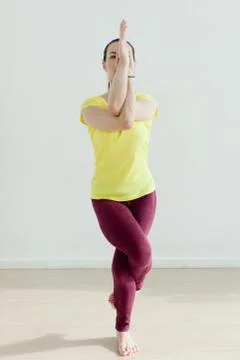 Woman practicing the eagle pose Stock Photos