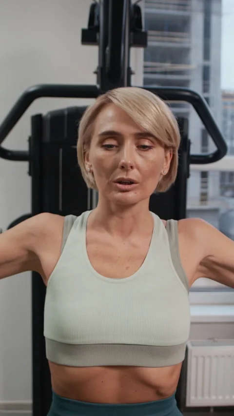 Woman Practicing Exercise in Pec Deck Machine in Gym Stock Footage 328337010