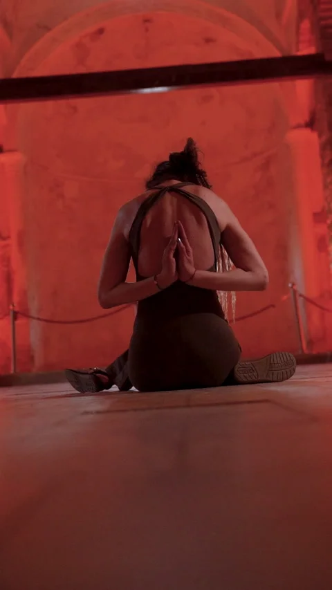 Woman practicing reverse prayer yoga pose inside historic Sirince church Video stock 336165551