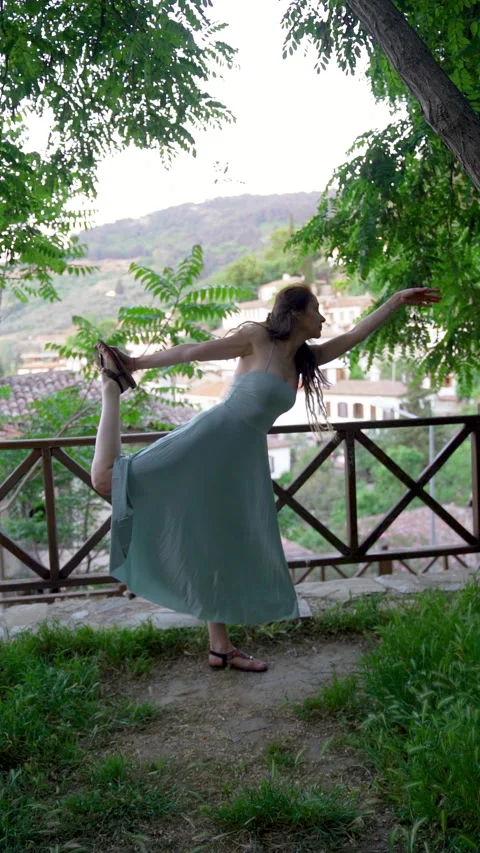 Woman practicing yoga dancer pose on a scenic terrace in Sirince Stock Footage 336164968