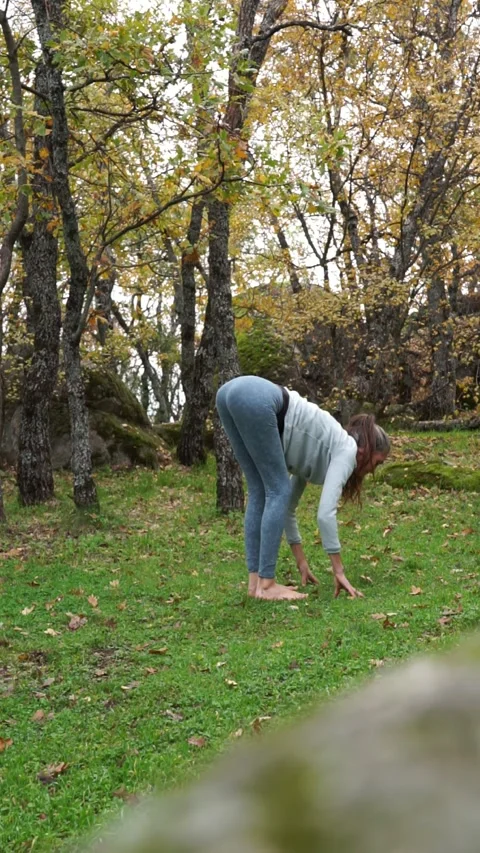 Woman practicing yoga in a forest Stock Footage 256165340
