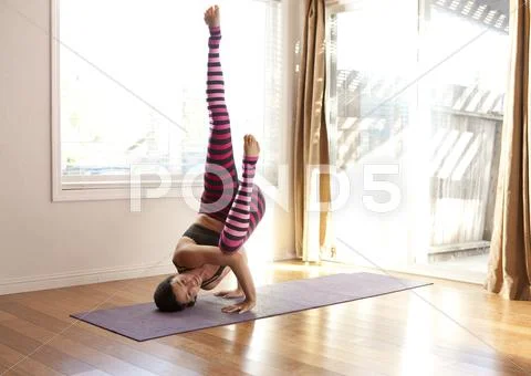 Woman Practicing Yoga In Studio