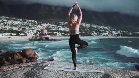 Woman Practicing Yoga Tree Pose by Ocean Coast Stock Footage 327446352