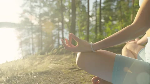 Woman practises yoga at sunrise in pine forest. Silhouette of young spiritual Video stock 204008564