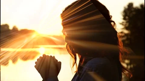 Woman in prayer by lake recieving the Ho... | Stock Video | Pond5