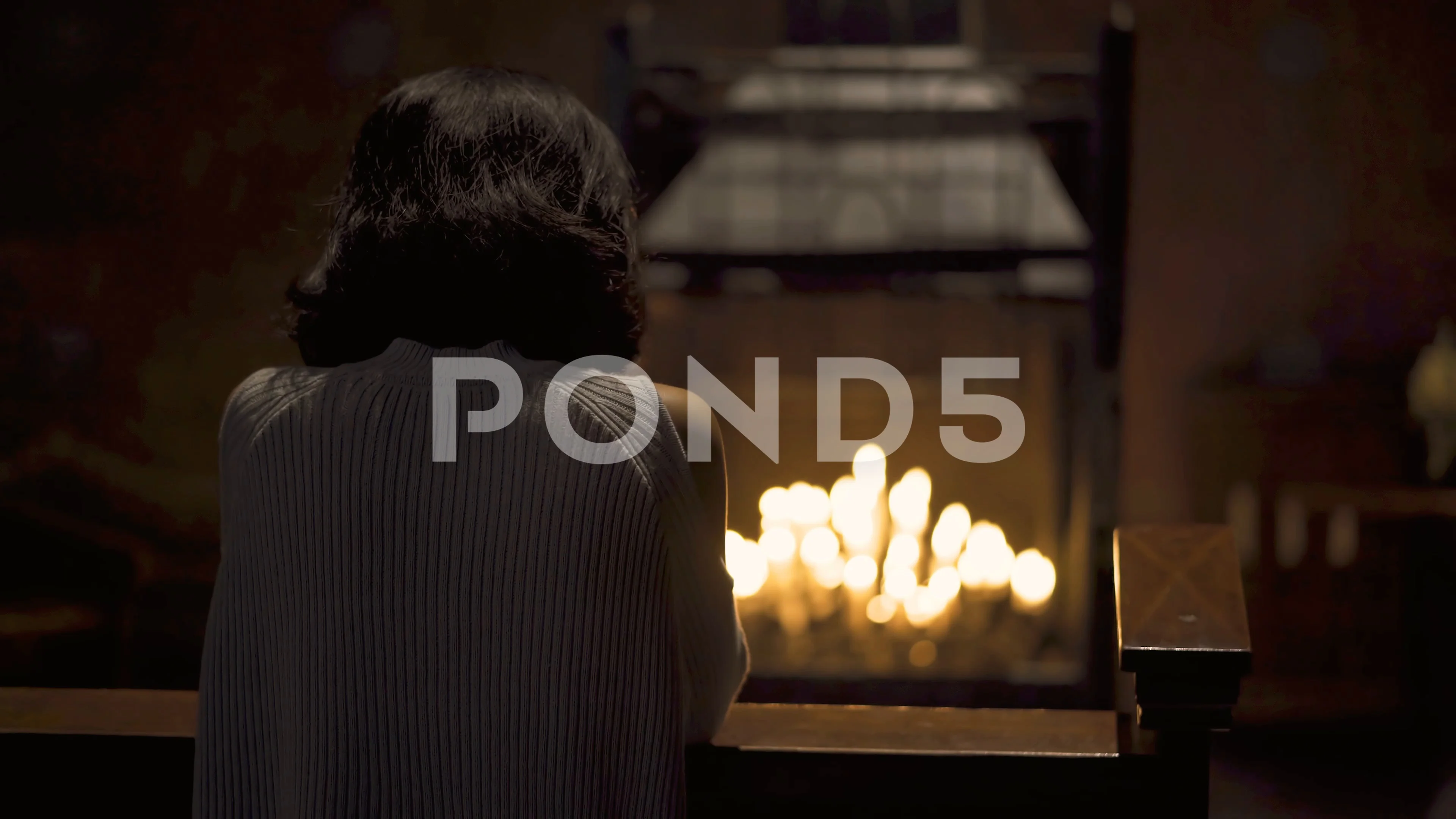 Woman praying in church with candle back... | Stock Video | Pond5