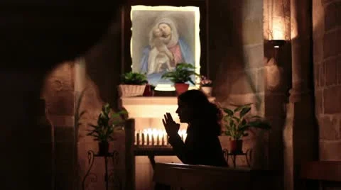 Woman praying in church Stock Footage