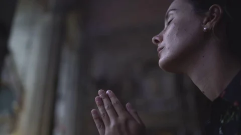 Woman praying in church Stock Footage