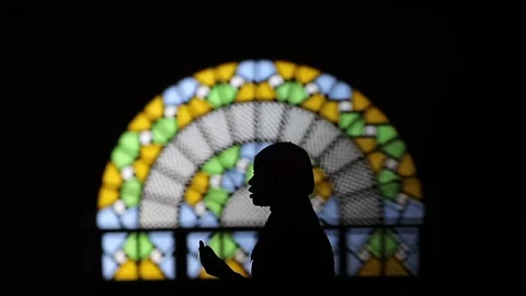 A woman praying in the mosque Stock Footage 148748629