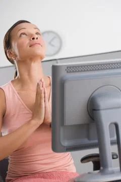 Woman praying in office Stock Photos
