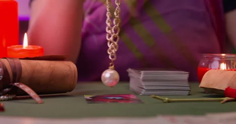 Woman predicts future for client using Tarot cards at table Stock Footage 260988372