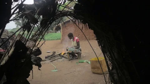 Woman prepares the fire view from inside hut Stock Footage 104499248