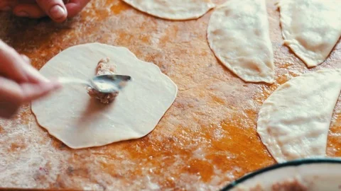 Woman prepares meat pies, working with the dough and filling, close-up Stock Footage