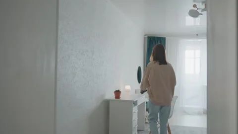Woman prepares room for study. She arranges furniture and opens curtains for Stock Footage 336864834