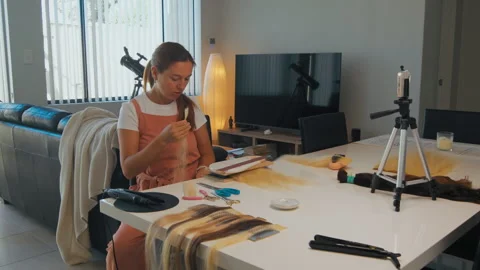 Woman prepares for a video tutorial at a table Stock Footage 330518259