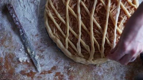 A woman is preparing an apple pie in a home kitchen Stock Footage