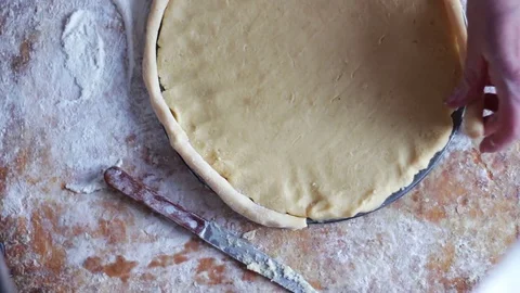A woman is preparing an apple pie in a home kitchen Stock Footage