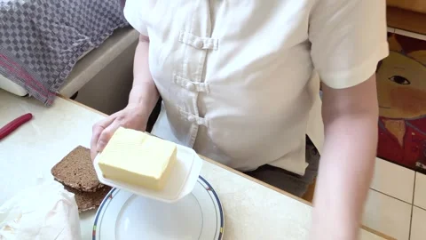 Woman Preparing Breakfast Ingredients at the Kitchen Table Stock Footage 342642656
