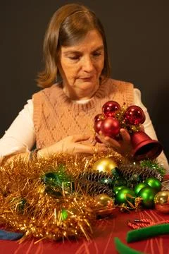 Woman preparing Christmas decorations making holiday crafts Stock Photos