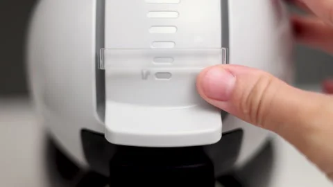 Woman preparing coffee using capsules in machine at home Stock Footage 247173025