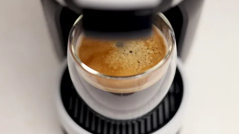 Woman preparing coffee using capsules in machine at home Stock Footage 247173040