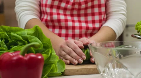 Woman preparing cucumber salad in kitchen Stock Footage 61071053