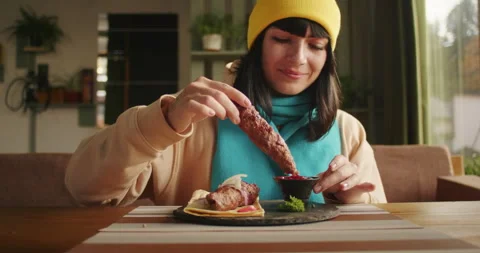 Woman preparing to eat a kebab at a restaurant table. Natural daylight and Stock Footage 273354053