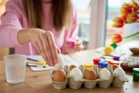 Woman preparing eggs for Easter decorating at home Stock Photos