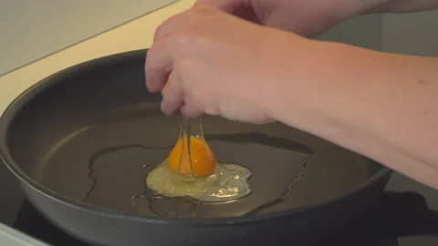 Woman preparing eggs in kitchen Stock Footage 144960941