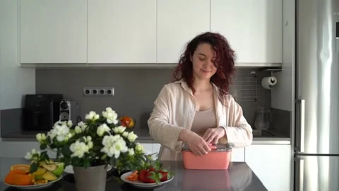 Woman preparing lunchbox kitchen Stock-Footage 240573790