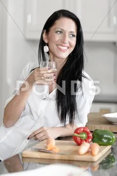 Woman preparing a meal in the kitchen Stock Photos
