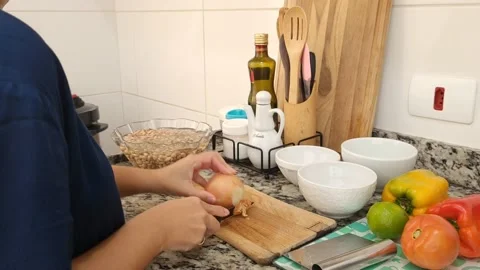Woman preparing or cooking in the kitchen cutting food Stock Footage 201554628