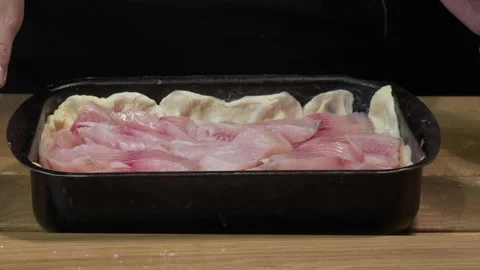 Woman is preparing a pie with fish 库存影片 133188803