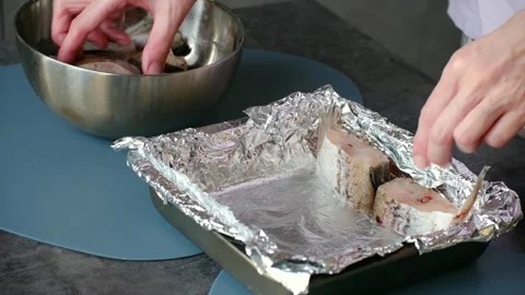 Woman preparing raw fish for baking in aluminum foil Stock Footage 337549585