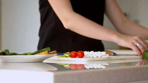 Woman preparing sandwich in kitchen Stock Footage 130063350