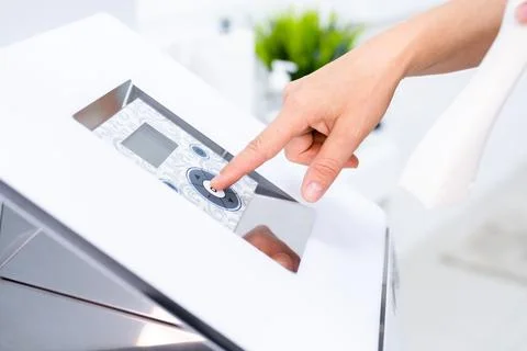 Woman press button on control panel of apparatus anticellulite LPG massage Foto stock