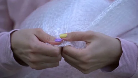 A woman presses a bubble wrap. Stock Footage 76283779